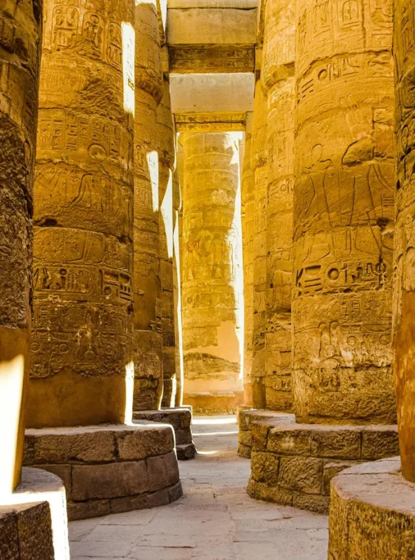 Sunlit ancient columns in the historic Karnak Temple Complex in Luxor, Egypt.