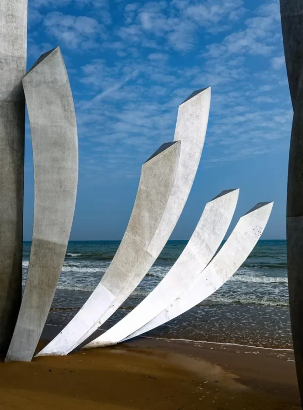 Stunning view of the Omaha Beach Memorial sculptures at Saint-Laurent-sur-Mer with the sea and sky as a backdrop.
