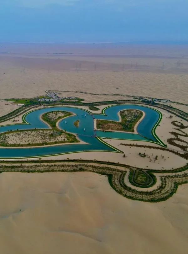 Drone shot of a heart-shaped oasis surrounded by desert landscape, symbolizing love.