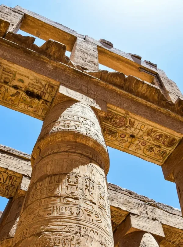 Close-up view of intricately carved columns at the Karnak Temple in Luxor, Egypt.