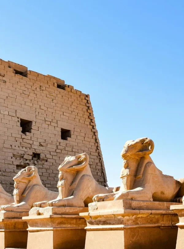 Row of ancient sphinx statues at the historic Karnak Temple Complex in Luxor, Egypt.
