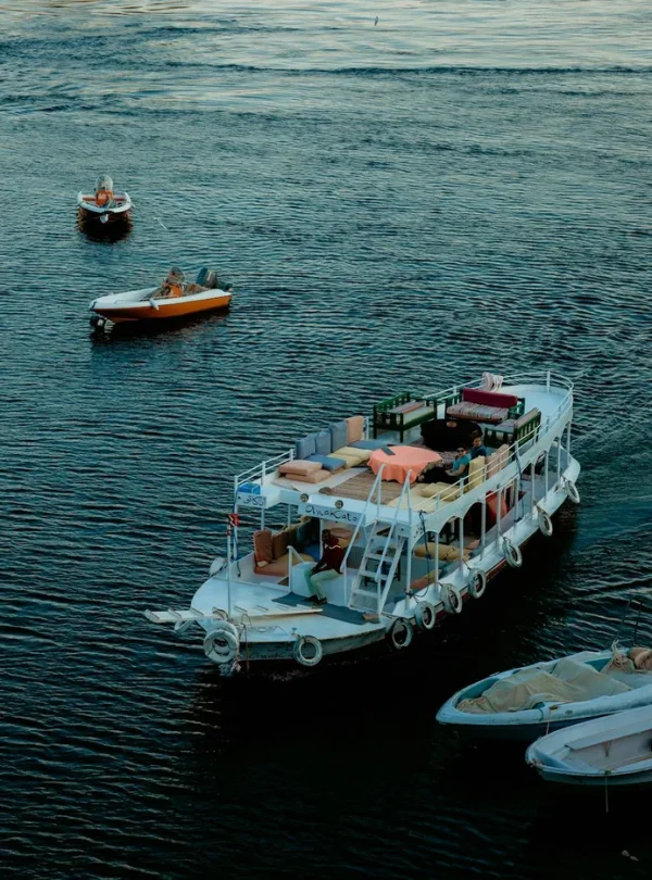 Scenic view of boats on the Nile River in Aswan, Egypt, showcasing vibrant travel and transportation.