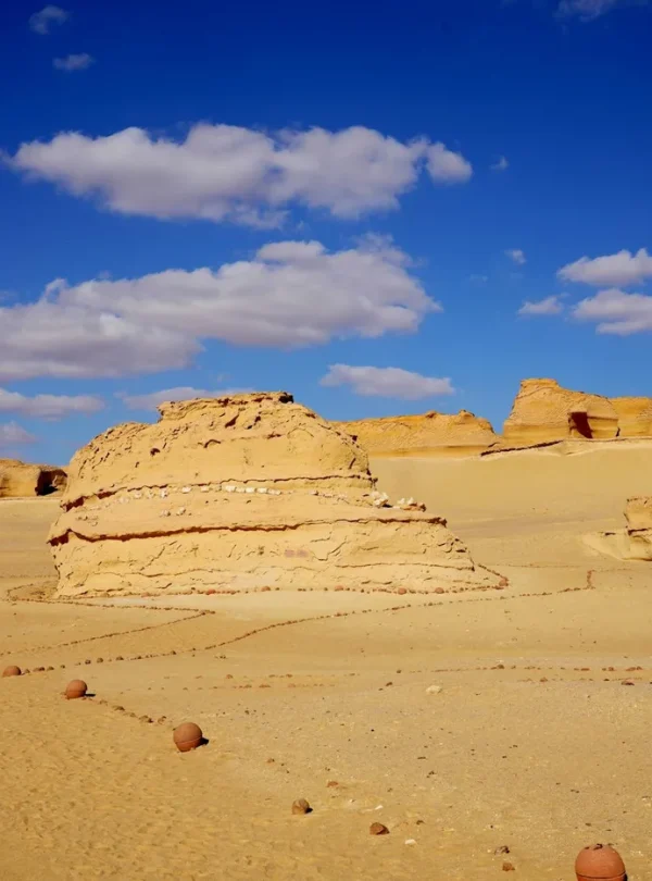 Vast desert landscape with rock formations and a clear blue sky in Egypt.