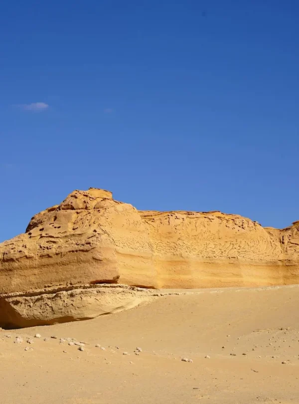 Breathtaking view of a unique sandstone formation under clear blue skies in Egypt's desert.